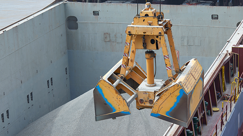 Loading bauxite on bulk carrier ship using grab bucket