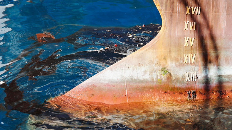  Black oil and rubbish around bow of large ship