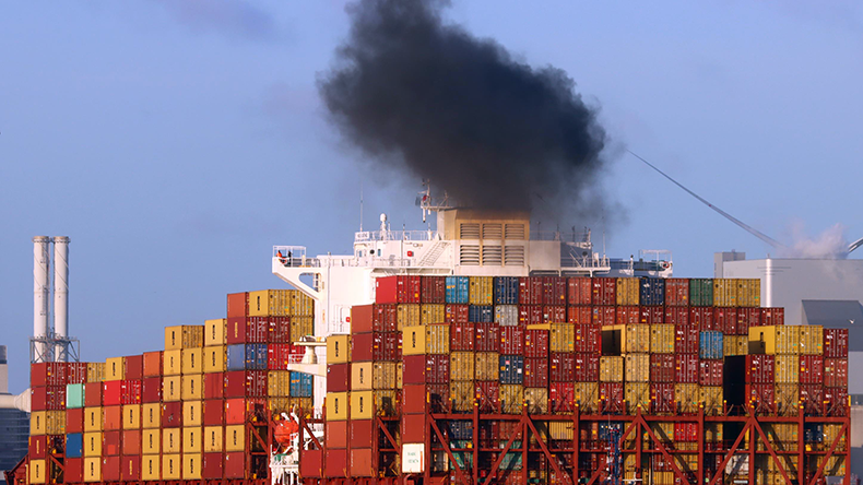Containership emitting black smoke from funnel