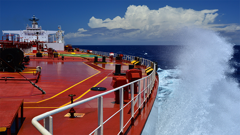 Deck of oil tanker with water spraying up