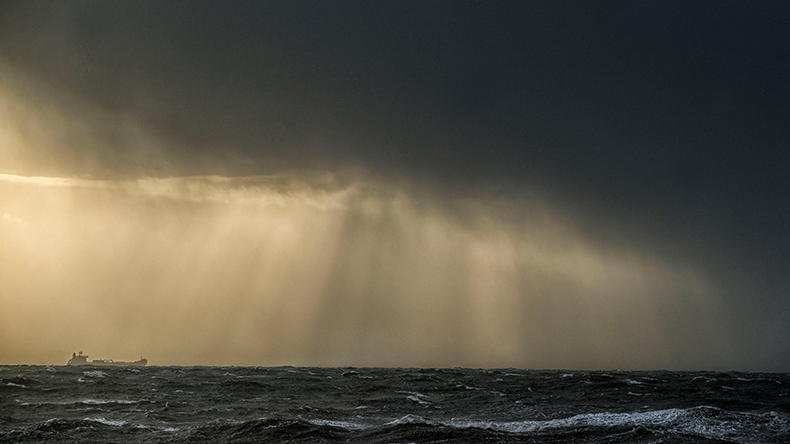 Ship heads into a storm in the Atlantic Ocean