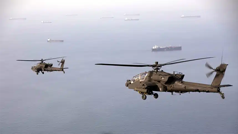 AH-64 Apaches fly above the Strait of Hormuz during a patrol