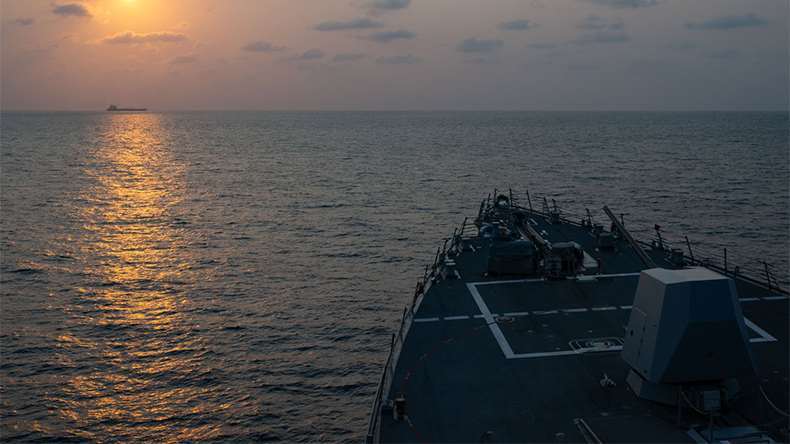 Guided-missile destroyer USS Pinckney (DDG 91) observes a merchant vessel while on patrol enforcing the U.S. blockade against Iran.