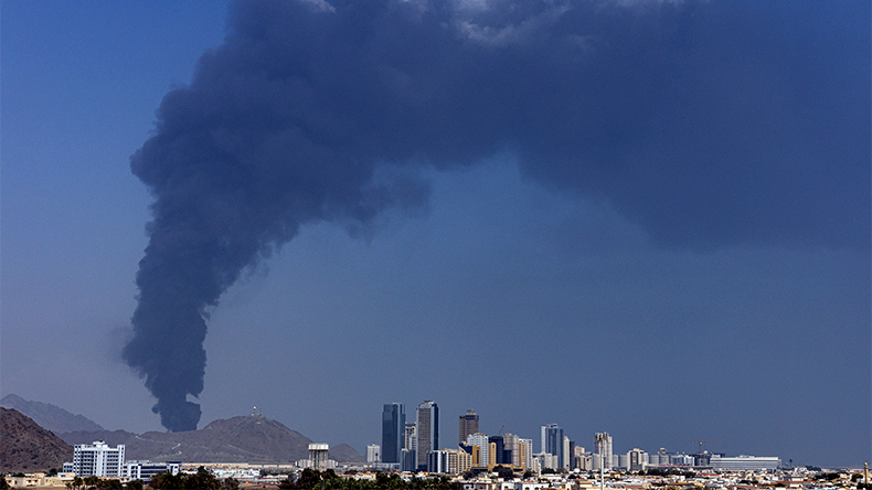 Smoke rises after an explosion in the industrial zone, caused by debris after interception of a drone by air defence, according to the Fujairah, United Arab Emirates