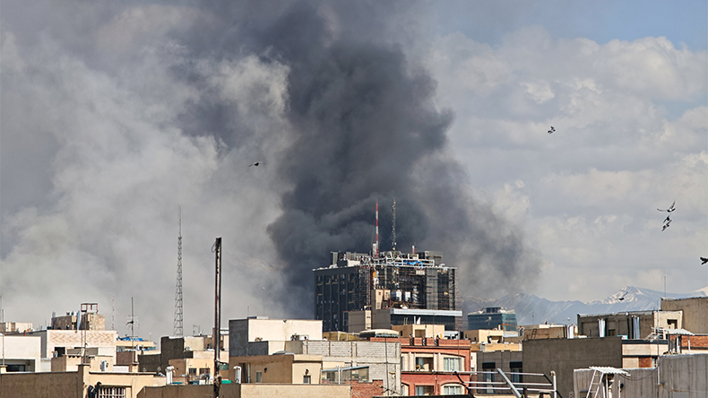 Plumes of smoke rise over the skyline following explosions on March 1, 2026 in Tehran, Iran