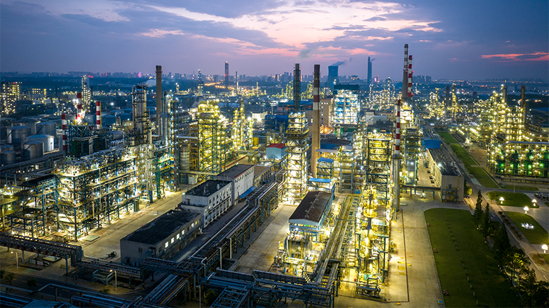Shot from drone of oil refinery plant, petrochemical plant at dusk