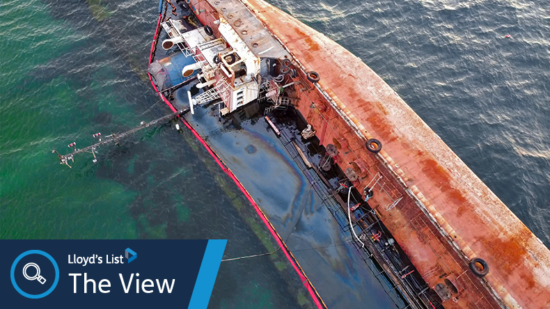 An overturned rusty tanker ran aground. Environmental disaster and oil spill into the sea