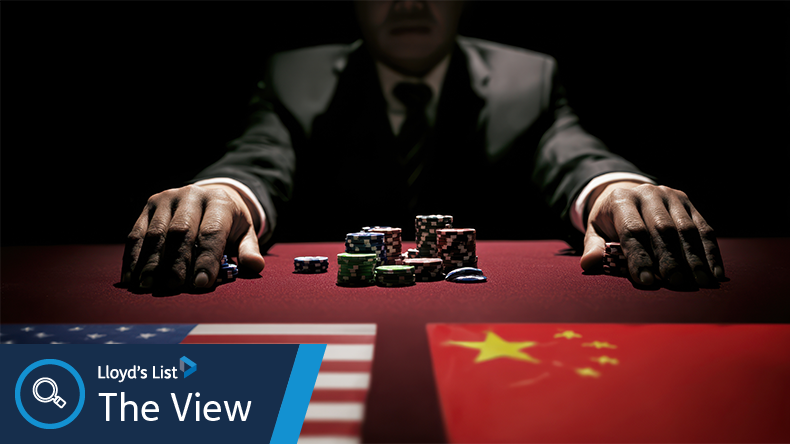 A man in a suit sits at a poker table with US and Chinese flags, symbolising geopolitical tension or strategic negotiations