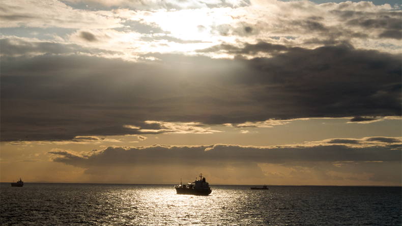 Ship at sea with sun setting